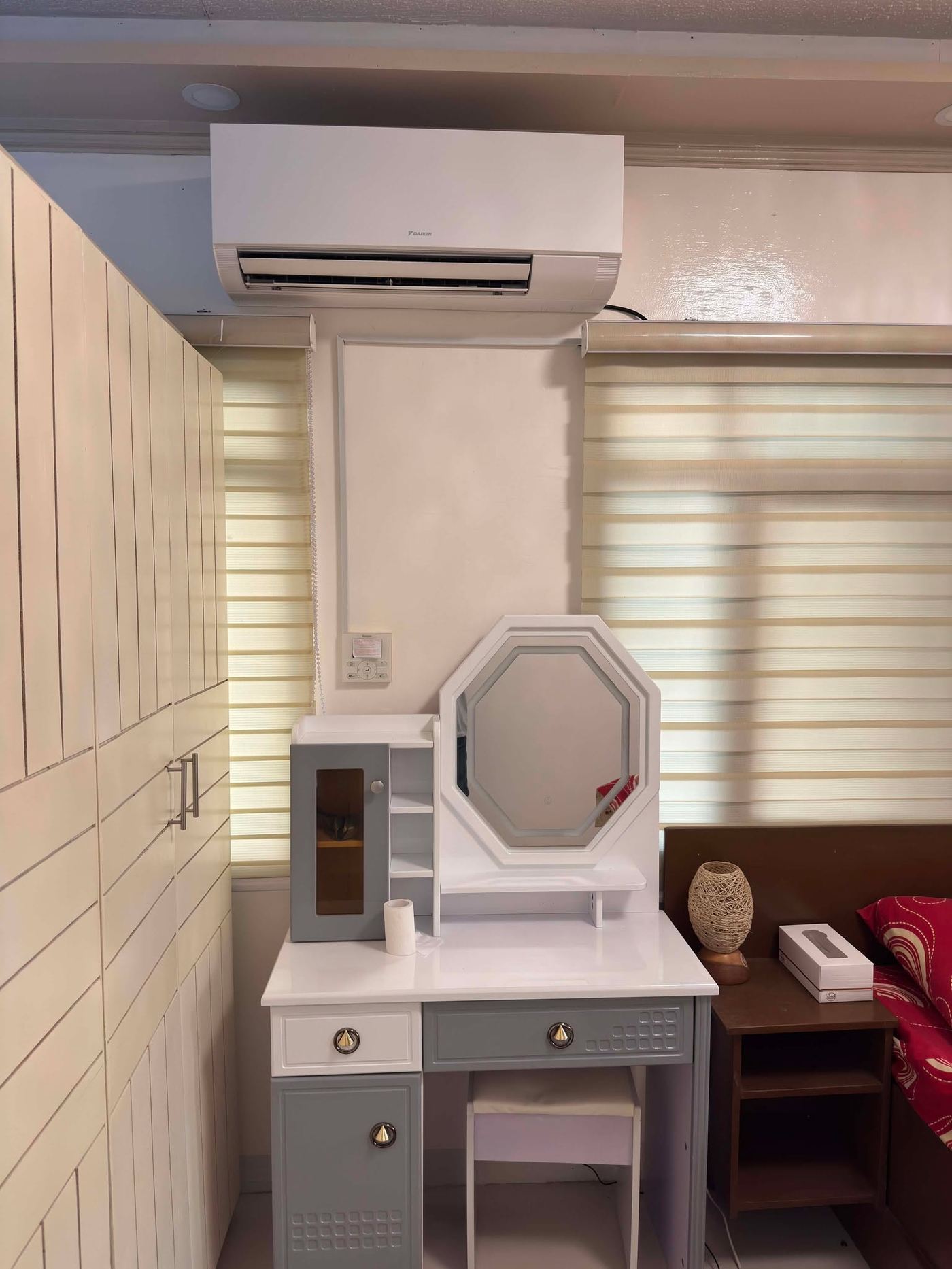 Bedroom with a Daikin wall-mounted split above fitted cabinets